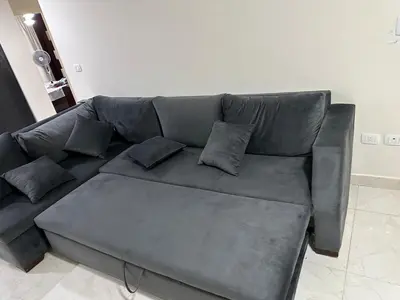 a gray couch with pillows on it in a living room at luxury apartment in Hurghada