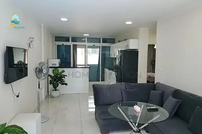 a living room with a blue couch and a glass table at luxury apartment in Hurghada