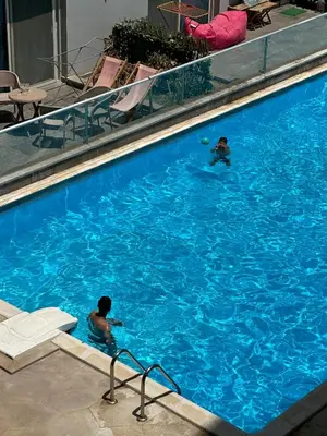 two people swimming in a large swimming pool at luxury apartment in Hurghada