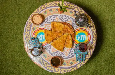 a plate of food with nachos and dips on it at Ekadolli Nubian house- by kerma hospitality in Aswan