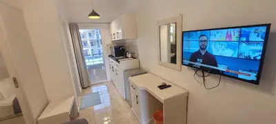 a living room with a flat screen tv on a wall at Gamela in Hurghada