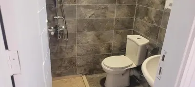 a bathroom with a toilet and a shower at Gamela in Hurghada