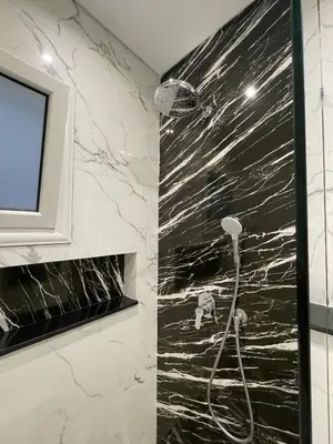 a bathroom with a shower with black and white marble at Endless Summer Apartment House W3 in Hurghada