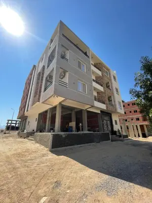 a building on the side of a dirt road at Endless Summer Apartment House W3 in Hurghada