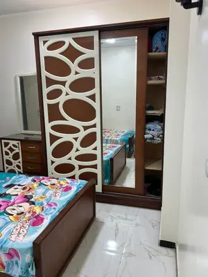 a bedroom with a mirror and a bed and a dressing room at شقة خلف فندق الإليزي in Hurghada
