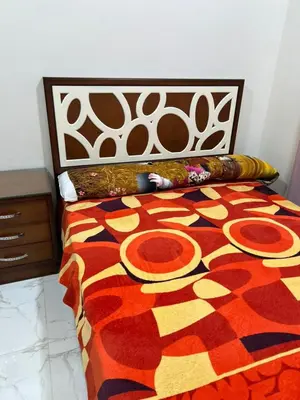 a bed with a colorful comforter on top of it at شقة خلف فندق الإليزي in Hurghada