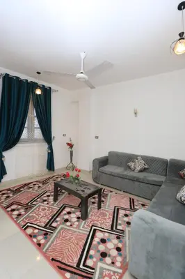a living room with a couch and a table at nile shores hotel in Al Aqālitah