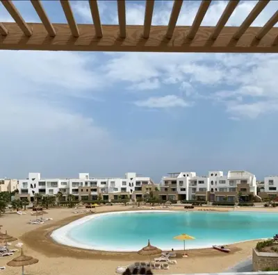 a view of a resort with a pool and a beach at Spacious Penthouse in Hurghada