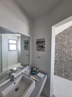 a bathroom with a sink and a mirror at Spacious Penthouse in Hurghada