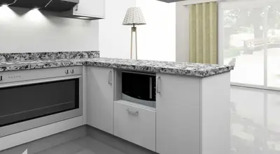 a kitchen with white cabinets and a counter top at Spacious Penthouse in Hurghada