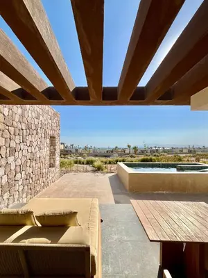 a patio with a couch and a stone wall at Villa with pool Miska Soma Bay in Hurghada