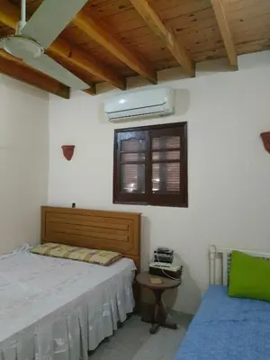 a bedroom with a bed and a window at El Soun Apartments in Luxor