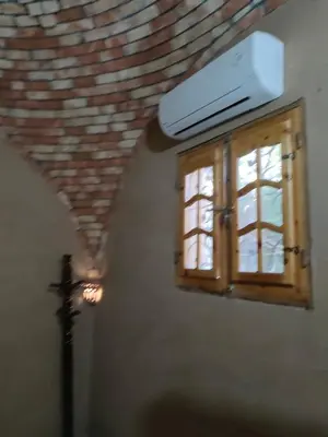 a kitchen with a window and a stove at El Soun Apartments in Luxor