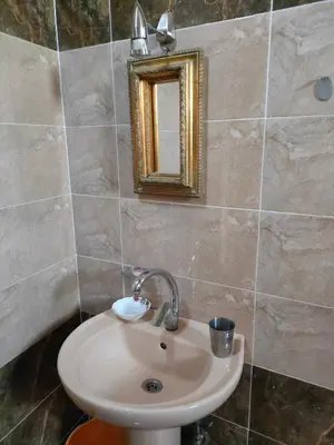 a bathroom with a sink and a mirror at El Soun Apartments in Luxor