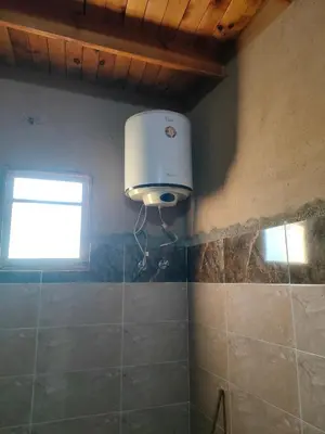 a bathroom with a air conditioner on the wall at El Soun Apartments in Luxor