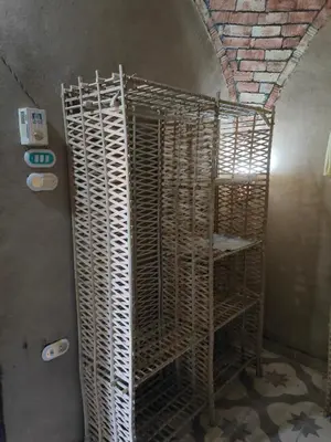 a stack of wooden shelves in a room at El Soun Apartments in Luxor