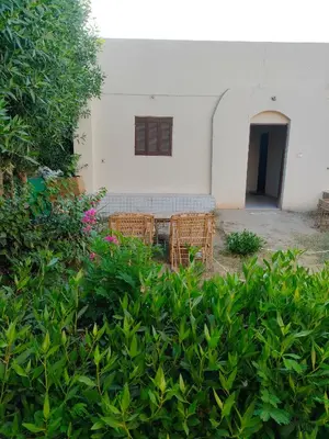 a table and chairs in front of a building at El Soun Apartments in Luxor