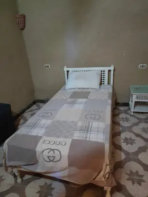 a bed sitting in a room with a mattress at El Soun Apartments in Luxor