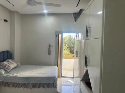 a bedroom with a bed and a glass wall at Eshyan Guest House in Aswan