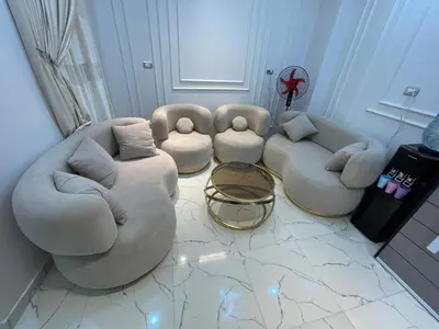 a living room with two couches and a table at Eshyan Guest House in Aswan