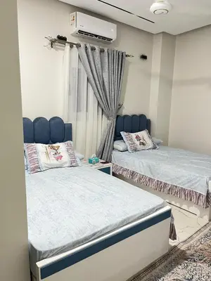 two beds sitting next to each other in a room at Eshyan Guest House in Aswan