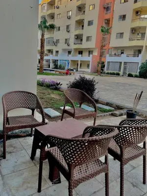 three chairs and a table and a table and chairs at Lotus Compound in the Inter Area in Hurghada