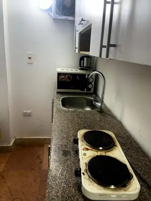 a kitchen counter with a stove and a sink at Lotus Compound in the Inter Area in Hurghada
