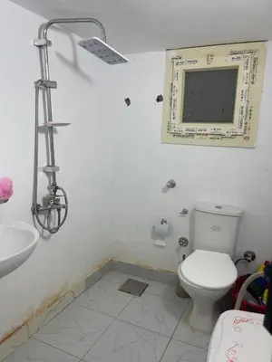 a bathroom with a toilet and a sink and a mirror at Lotus Compound in the Inter Area in Hurghada