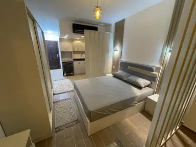 a small bedroom with a bed and a kitchen at 1BR Relaxing Seaside Retrear Shal Hasheesh in Hurghada
