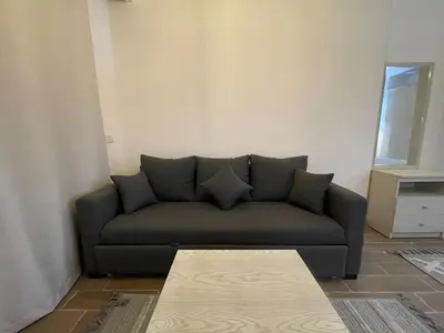 a living room with a couch and a table at 1BR Relaxing Seaside Retrear Shal Hasheesh in Hurghada