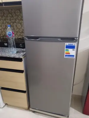 a refrigerator in a kitchen with a bottle of water at استوديو في ذهبية طيبة جولدن الغردقة in Hurghada