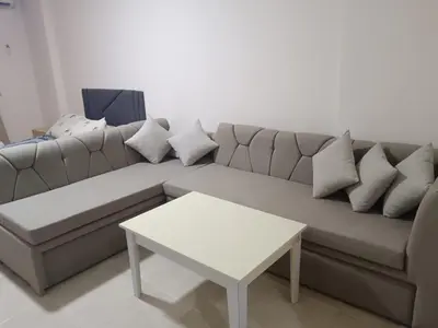 a living room with a couch and a table at استوديو في ذهبية طيبة جولدن الغردقة in Hurghada