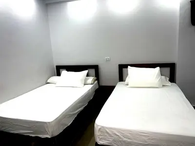 two beds sitting next to each other in a room at Palma Resort in Hurghada