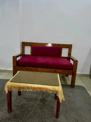 a wooden bench with a purple pillow on it at Palma Resort in Hurghada