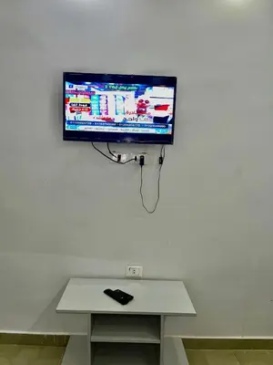 a flat screen tv hanging on a white wall at Palma Resort in Hurghada