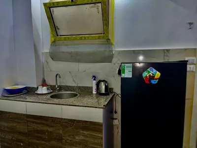 a small kitchen with a sink and a refrigerator at Palma Resort in Hurghada