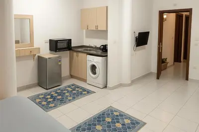 a kitchen with a washer and dryer in a room at Majestic apartments in Hurghada