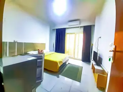 a room with a bed and a tv in it at Majestic apartments in Hurghada