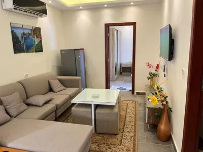 a living room with a couch and a table at Dream Chalet In Mirage Bay Resort in Hurghada