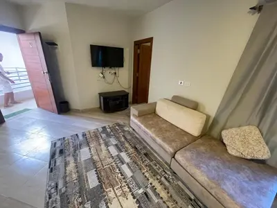 a living room with a couch and a tv at marvel princes in Hurghada