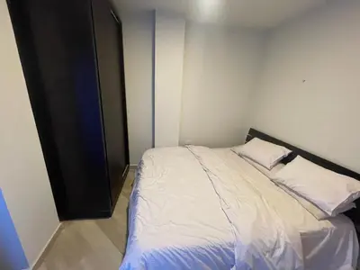 a small bedroom with a bed with white sheets at marvel princes in Hurghada