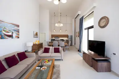 a living room with a couch and a tv at VESTA - El Gouna Residence in Hurghada