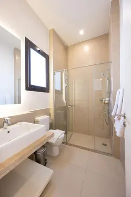 a bathroom with a sink toilet and a shower at VESTA - El Gouna Residence in Hurghada