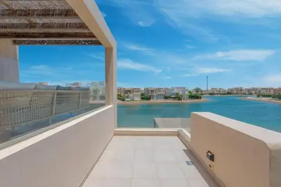 a balcony with a view of the water at The Lake View Villa 4BR at Tawila El Gouna in Hurghada