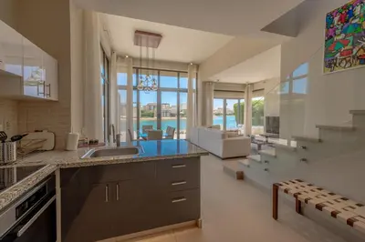 a kitchen with a sink and a living room at The Lake View Villa 4BR at Tawila El Gouna in Hurghada