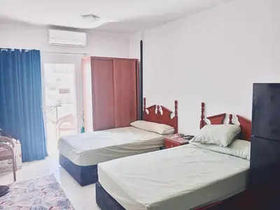 a room with two beds and a window at Tiba view in Hurghada