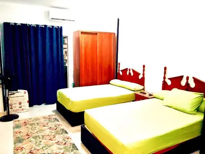 a bedroom with two beds and blue curtains at Tiba view in Hurghada