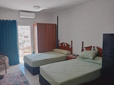 a hotel room with two beds and a window at Tiba view in Hurghada