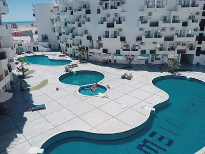 an aerial view of a building with two swimming pools at Tiba view in Hurghada