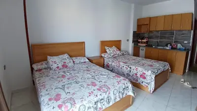 a bedroom with two beds and a kitchen at Tiba view in Hurghada